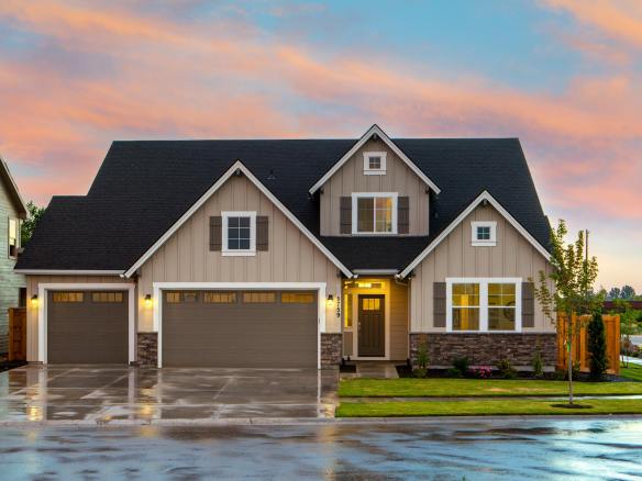 brown and gray painted house in front of road